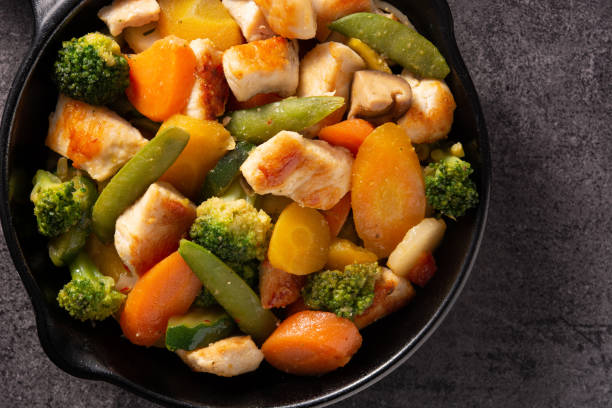 istock Stir fry chicken with vegetables on iron pan 1278813077