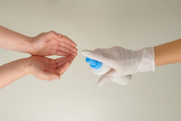 istock hands in rubber gloves disinfecting child hands with sanitizer 1278814143