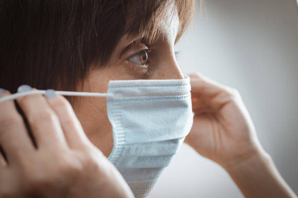 istock Woman with a disposable mask 1278814335