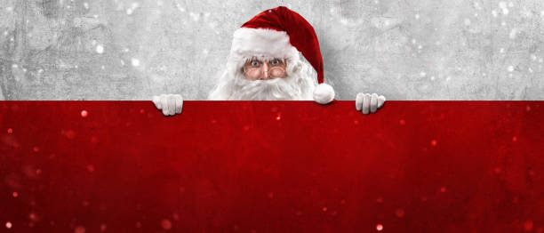 istock Santa Claus Showing Something On a Red Wall 1278814671