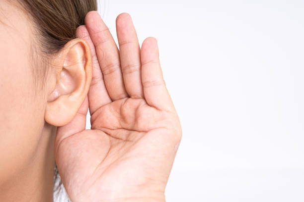 woman hearing loss or hard of hearing and cupping her hand behind her ear isolate on white background, Deaf concept. woman hearing loss or hard of hearing and cupping her hand behind her ear isolate on white background, Deaf concept. hands cupped stock pictures, royalty-free photos & images