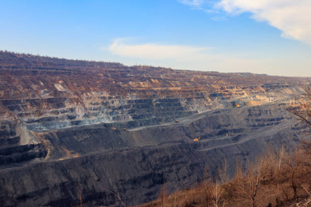 istock Huge iron ore quarry with working dump trucks and excavators 1278815899
