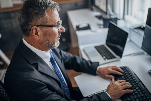 istock An older businessman works in an office 1278817093