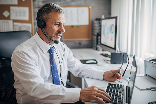 Smiling female call center representative wearing headset