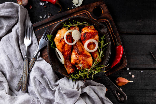 istock Baked chicken legs in a cast iron pan close-up, top view 1278819788