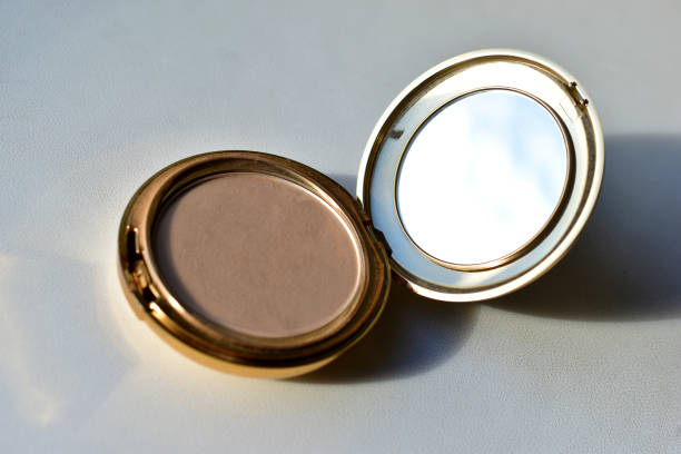 istock Gold round compact with mirror on white background 1278819950