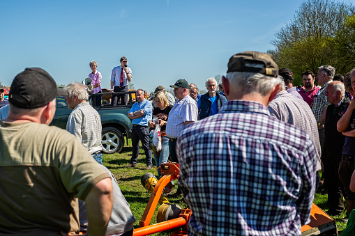 Auctioneer selling farming equipment at outdoor auction at Standerwick Market, Frome, Somerset, UK taken on 19 April 2018