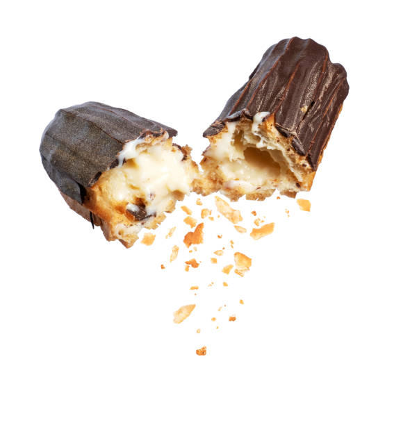 istock Delicious chocolate eclair broken into two halves in the air close-up on a white background 1278821660