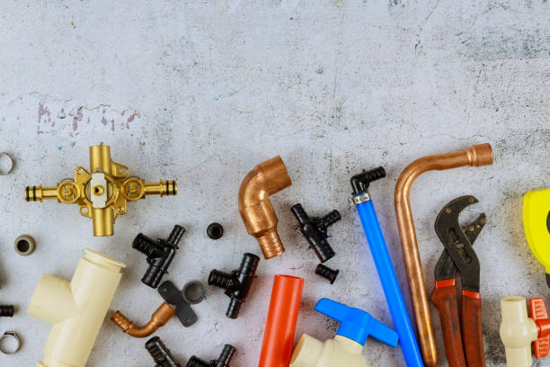 istock Plumbing tools, pipe fittings on a home improvement plumbing materials including copper pipe, elbow joint, wrench and spanner. 1278824823