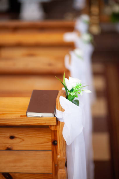 istock Prayer book on a bench in a church 1278826598