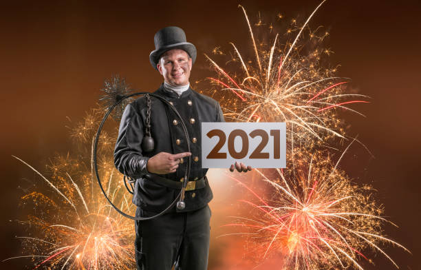 istock Chimney sweeper with billboard new year 2021 standing in fireworks 1278827892