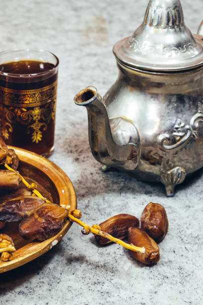 istock Traditional Moroccan Mint Tea with silver teapot, Arabic drink and  ripe dates 1278829376