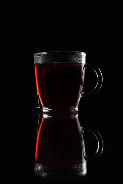 Photographing the product - tea in a cup on a black background.