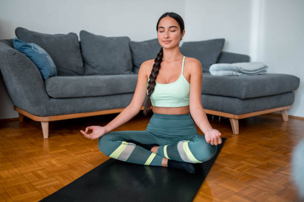 istock Asian Young Woman Practicing Yoga At Home 1278833245