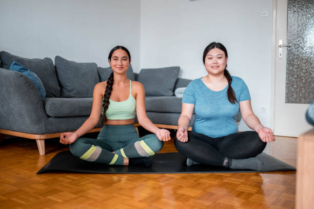 istock Asian Friends Practicing Yoga At Home And Looking At Camera 1278833312