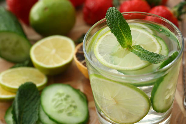 Delicious fresh mojito and limes on table