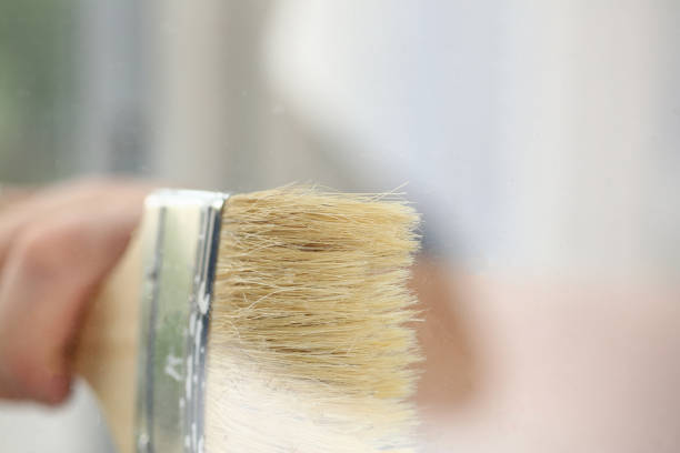 istock Male hand using paint brush with wooden handle 1278834875