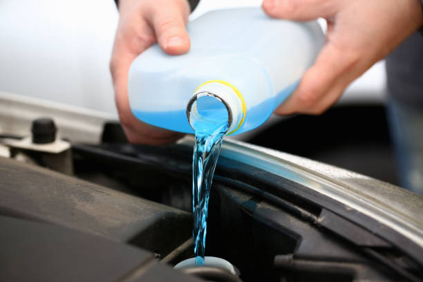 istock Young man pouring motor oil into car engine 1278836133