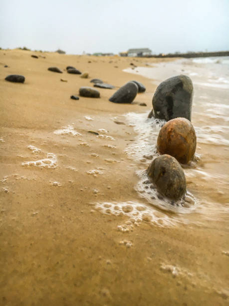 istock Stones on the beach in a line 1278838170