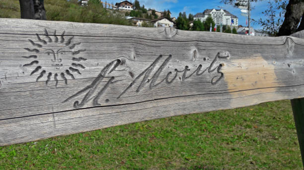 istock St. Moritz inscription engraved on a wooden bench 1278838194