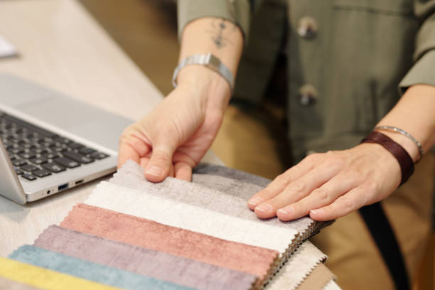 istock Hands of manager of studio of interior design looking through fabric samples 1278838473