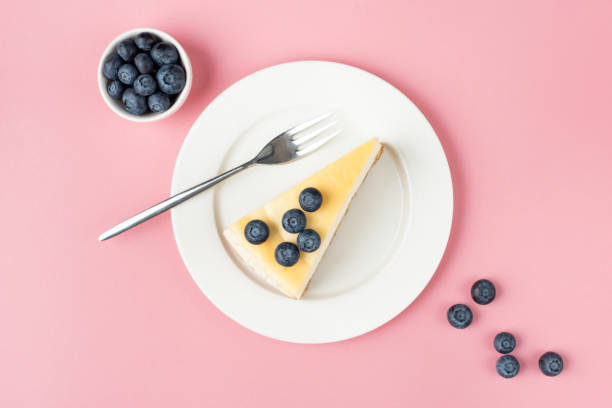 istock Cheesecake with blueberries on pink background 1278838673