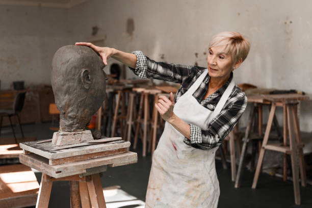 istock Senior sculptor working on clay bust 1278839682