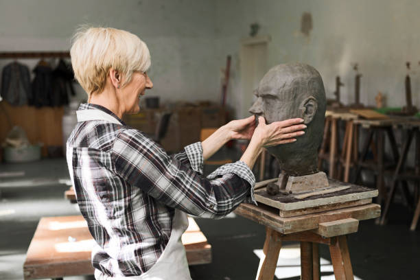 istock Senior sculptor working on clay bust head 1278839690