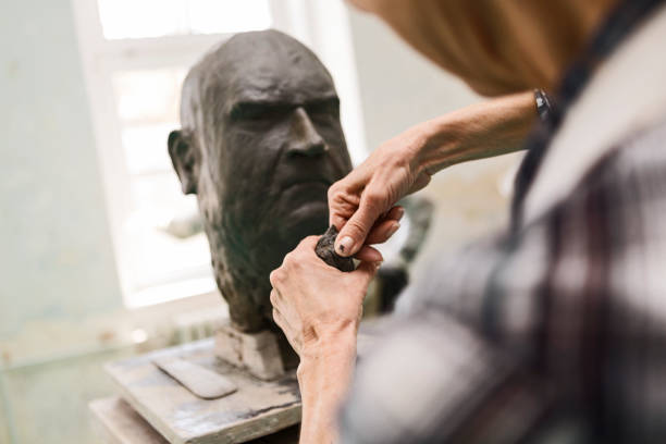 istock Senior sculptor working on clay bust ,molding clay 1278839705