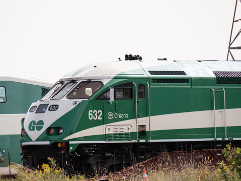 Toronto Canada, September 14, 2020; A green GO train MotivePower Industries MPI diesel locomotive waiting in the marshaling yards at Union Station in Toronto