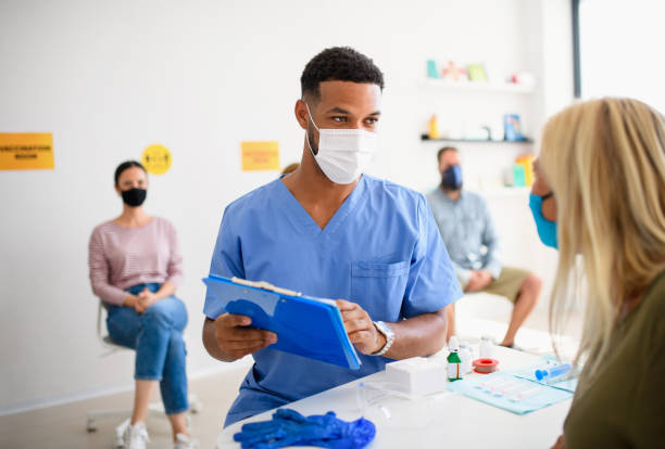 istock People with face mask getting vaccinated, coronavirus, covid-19 and vaccination concept. 1278840988