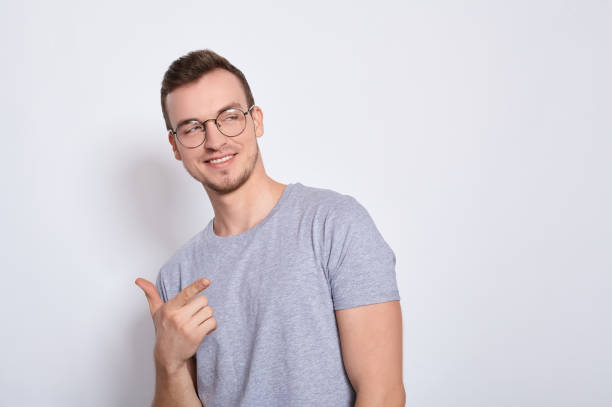 istock A stylish young man shows his hand to the side. 1278841740