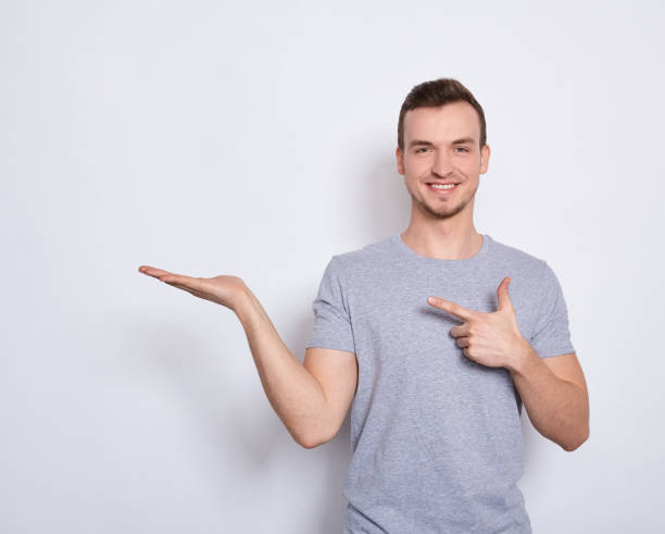 istock The young guy points his finger to the side. 1278841859