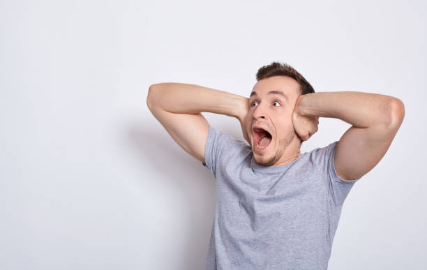 istock Shocked screaming young guy in T-shirt. 1278842526
