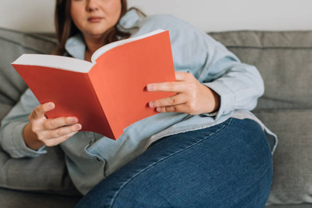 istock Anonymous Woman Reading a Book at Home, a Close Up 1278843089