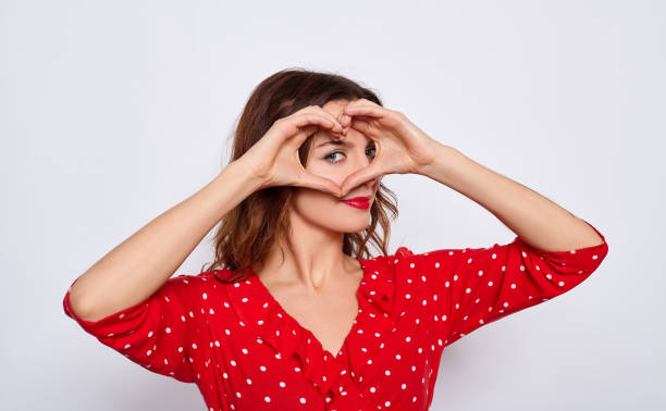 istock A beautiful sensitive white lady shows her heart with her hands. 1278843122