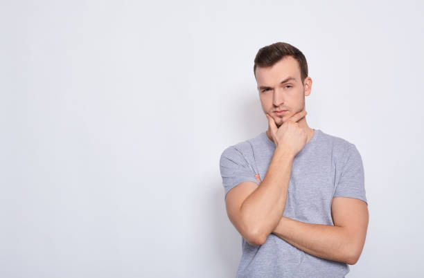 istock Thoughtful, bored young Caucasian guy on a white background. 1278844423