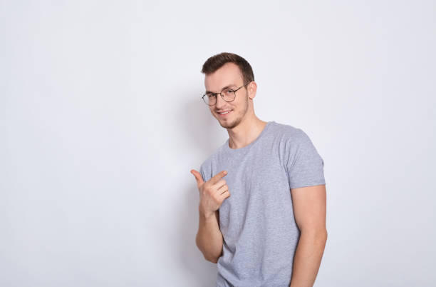 istock Charming funny guy points at someone with his finger. 1278844518