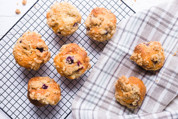 istock Blackberry muffin on a cooling rack and rustic napkin.. 1278844526