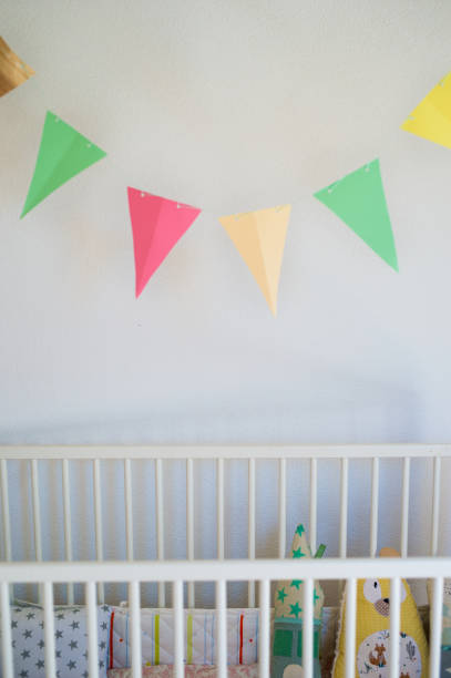 istock Cot in bedroom decorated for newborn baby. 1278844556