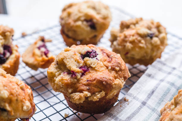 istock Blackberry muffin on a cooling rack and rustic napkin.. 1278844632