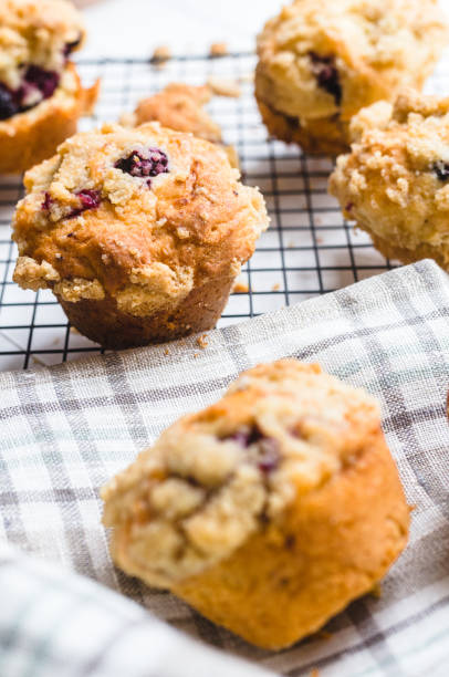 istock Blackberry muffin on a cooling rack and rustic napkin.. 1278844740