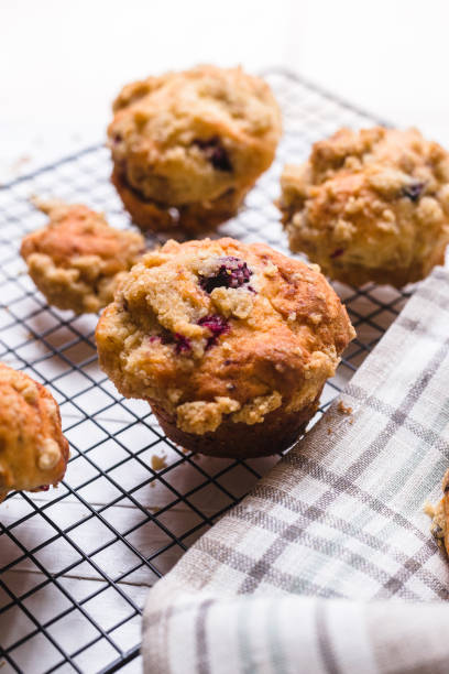 istock Blackberry muffin on a cooling rack and rustic napkin.. 1278844777