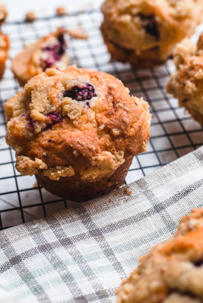 istock Blackberry muffin on a cooling rack and rustic napkin.. 1278844779