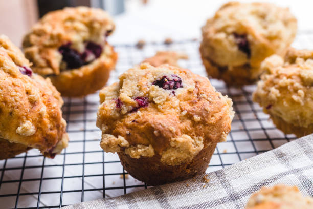istock Blackberry muffin on a cooling rack and rustic napkin.. 1278844861