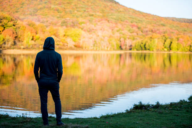 istock Young man surrounded by vibrant autumn colors. 1278847315