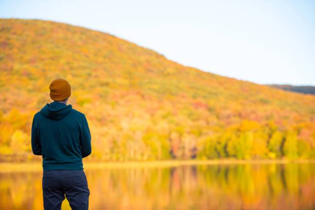 istock Young man surrounded by vibrant autumn colors. 1278847353