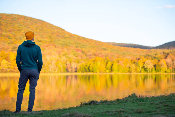 istock Young man surrounded by vibrant autumn colors. 1278847372
