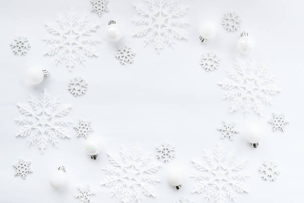 istock Pattern made of white balls and snowflakes on white background. 1278848592