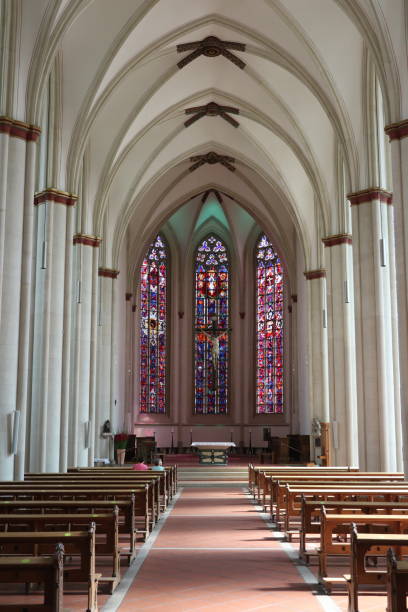 istock catholic Church interior with colorful stained glass and columns 1278849648